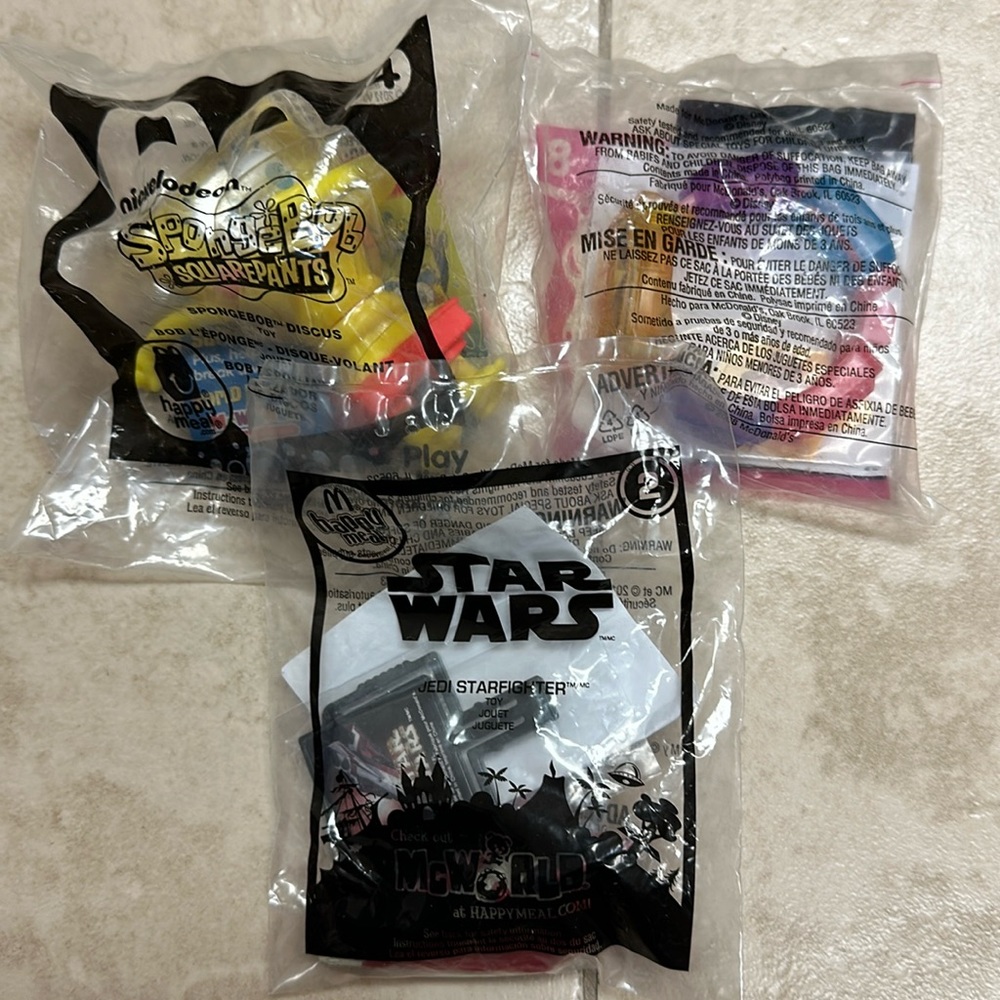 McDonald’s happy meal toys: SpongeBob, Belle’s toy bracelet, Jedi star-fighter
